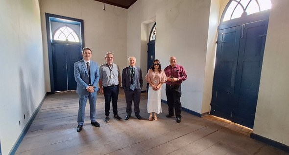 Na fotografia aparece um grupo de pessoas posando para foto no ambiente interno do Casarão dos A...