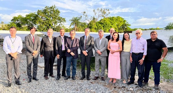#PraTodosVerem: Na fotografia interna um aparece um grupo de pessoas posando em frente aos painé...