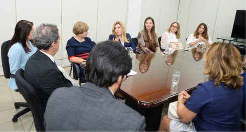 #PraTodosVerem: Um homem e uma mulher  conversam sorrindo durante a reunião, sentados lado a lad...