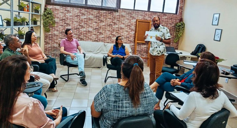 SAS promove encontro do Grupo Terapêutico de Suporte Emocional_CAPA #PraTodosVerem: Na fotografia aparece um homem em pé, em uma sala iluminada dialogando para um g...