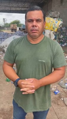#PraTodosVerem: Na fotografia aparece um homem em um pátio de reciclagem, em pé. No fundo, há um...