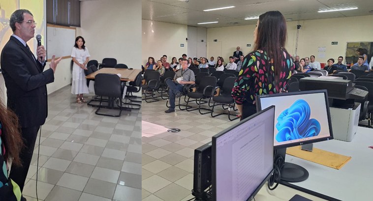 TRE-PB semana de saúde #ParaTodosVerem: Homem, de pé, fala ao microfone para plateia em sala de treinamento.