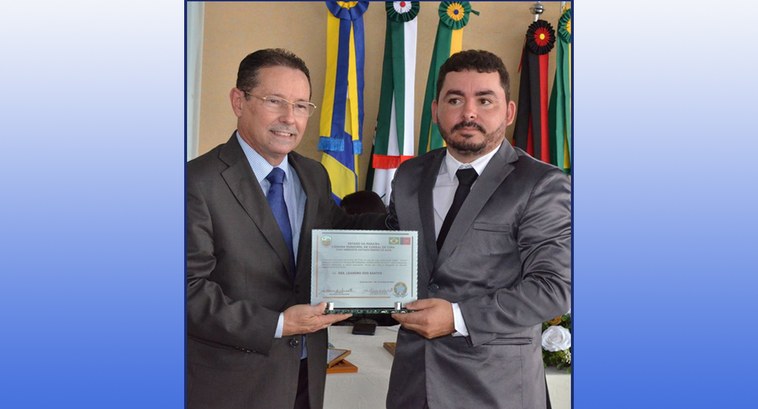 #ParaTodosVerem: Dois homens segurando pelos lados um título de cidadania, eles estão de terno e...